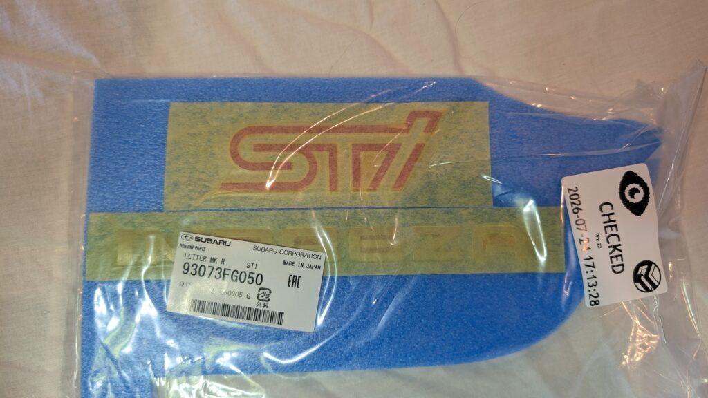 93073FG050 Subaru OEM STI Rear Letter Mark Badge